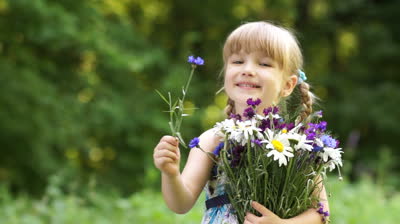 stock-footage-girl-smelling-flower-in-the-open-space